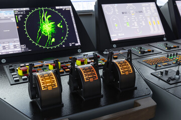 Modern ship control panel with radar screen and digital navigation units
