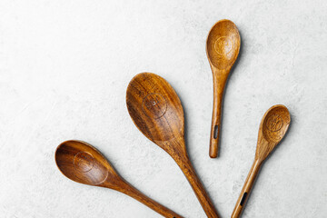 Wooden kitchen utensils arranged on a light background for culinary use