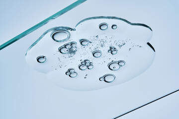 The texture of a clear shower gel or shampoo with bubbles. View from below.