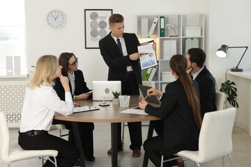 Group of coworkers having meeting in office