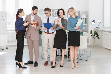 Fototapeta premium Group of confident coworkers in formal clothes indoors