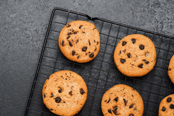 Freshly baked chocolate chip cookies cooling on a wire rack