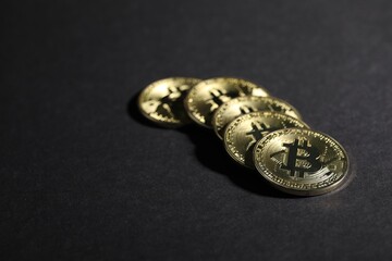 Cryptocurrency. Golden bitcoins on grey background, closeup