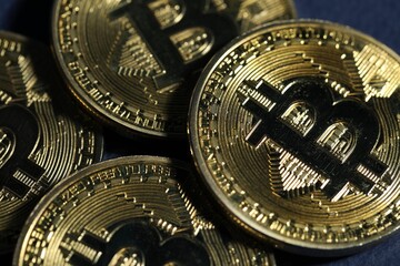 Cryptocurrency. Golden bitcoins on dark blue background, closeup