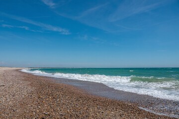 beautiful deserted beach at Selsey West Sussex England with blue sky in the background