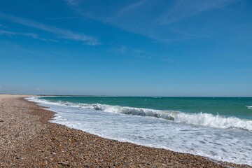 beautiful deserted beach at Selsey West Sussex England with blue sky in the background