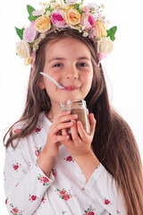 Beautiful bulgarian girl wearing traditional folklore costume eating bulgarian sweet meal ashura made from wheat, rose water, nuts and dried fruits