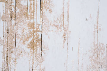 White wall with textured peeling paint and damaged surface with vertical streaks