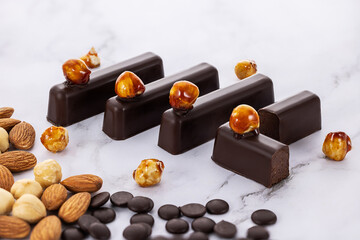 Delicious Chocolate Bars with Almonds, Hazelnuts on Marble Background