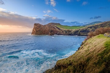 South coast of Sao Jorge (Azores islands) near Velas with volcanic rock Morro de Lemos. Breathtaking view of the dramatic cliffs and turquoise waters of Sao Jorge, Azores.