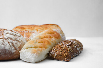 Freshly baked artisan bread assortment on a white background