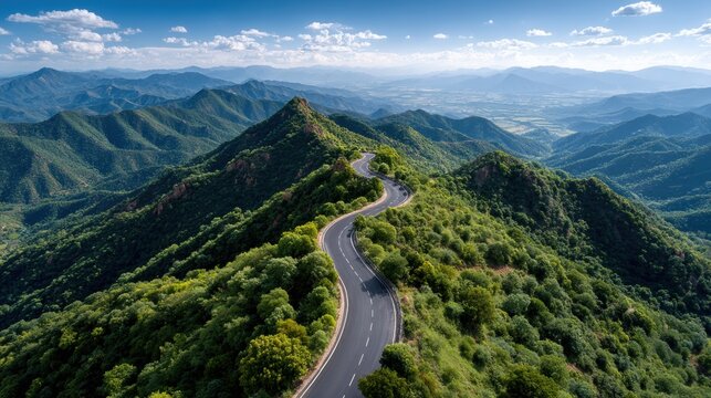 Serpentine Mountain Road: Aerial View of Scenic Winding Path in Green Landscape under Blue Sky