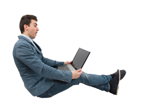 Full length portrait of a seated businessman looking amazed at a laptop monitor on his knees isolated on transparent background. Global network speed concept