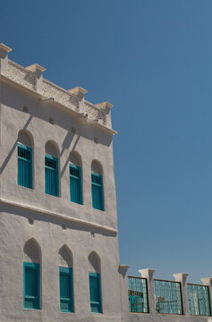 Oman, 03-10-2025: white house with blue windows on Mutrah Corniche, typical skyline of Old Muscat, the original historic city of Muscat, the capital of Oman on the coast in the Gulf of Oman