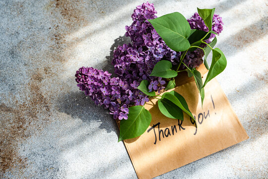 Lilac Bouquet with Thank You Note on Rustic Surface