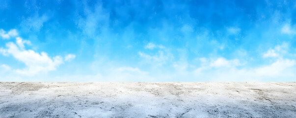 Obraz premium Vast barren landscape under a bright blue sky with minimal clouds during midday sunlight