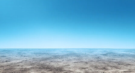 Obraz premium Vast barren landscape under a bright blue sky with minimal clouds during midday sunlight