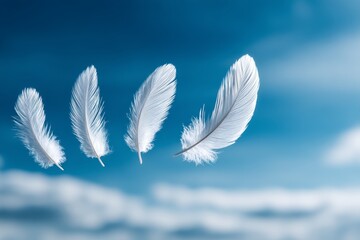 Naklejka premium White Feathers Floating in Sunny Sky - Four white feathers drift peacefully against a vibrant blue sky, symbolizing freedom, lightness, hope, serenity, and spiritual ascension
