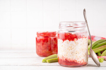 Sweet rhubarb overnight oats in portioned jar. Summer tasty healthy vegan food. Dietary breakfast...