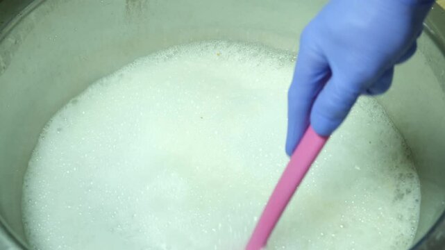Cleaning a metal kitchen sink with sodium percarbonate powder dissolved in hot water. The rich oxygen foam works well on stains and limescale.