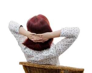 Rear view of a young woman sitting on a chair imagining a work break. Businesswoman portrait resting and dreaming of vacation. Relaxing body and calming mind concept isolated on transparent background