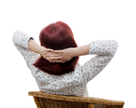 Rear view of a young woman sitting on a chair imagining a work break. Businesswoman portrait resting and dreaming of vacation. Relaxing body and calming mind concept isolated on transparent background