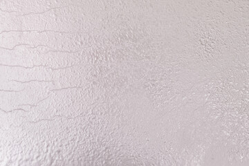 Shiny silver pearl metallic paper texture with glitter accents. Rich, luxurious festive backdrop.