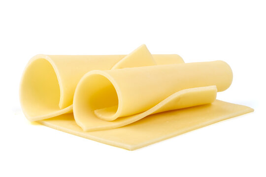 Rolled cheese slices isolated on white background.
