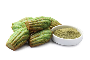 Tasty madeleine cakes and matcha powder isolated on white