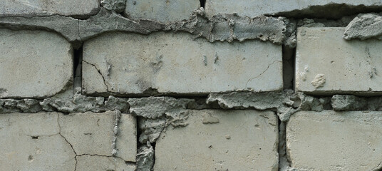 An old shabby white brick wall background. Close up.