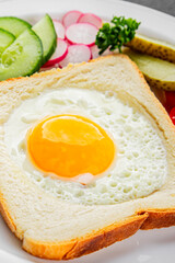 Fried gashouse eggs in bread egg in the basket delicious snack breakfast in a bowl fresh delicious gourmet food background on the table rustic food top view copy space