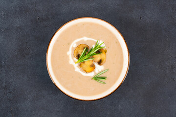 Delicious and healthy mushroom soup on black background