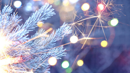 New Year or Christmas background with sparklers. Background of New Year's bokeh, Christmas mood,...