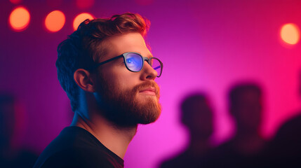 Portrait of a Man with Red Curly Hair and Beard Wearing Glasses in a Pink and Purple Lit Setting