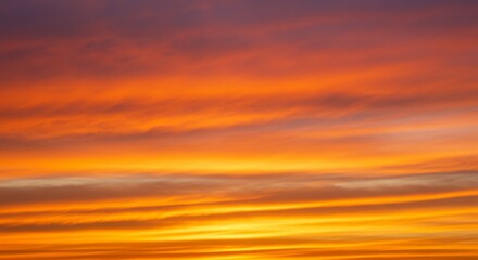 Obraz premium Vibrant Orange And Red Sunset Sky With Clouds