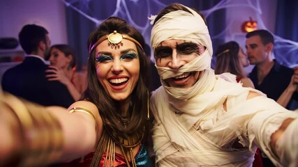 Elaborate Halloween Couple Costume Party Selfie with Cleopatra Pharaoh and Realistic Ancient Egyptian Mummy Makeup with Guests and Prop Decorations