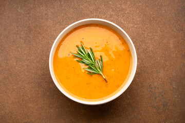 Delicious lentil, ezogelin or pumpkin soup on brown stone background