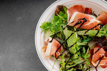 Salad food jamon meat green leaf lettuce appetizer natural fresh gourmet food background on the table rustic food top view copy space keto and paleo diet