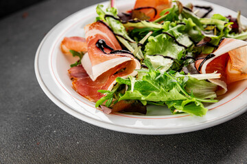 Salad food jamon meat green leaf lettuce appetizer natural fresh gourmet food background on the table rustic food top view copy space keto and paleo diet