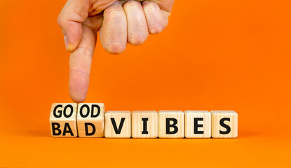 Good or bad vibes symbol. Concept words Good vibes Bad vibes on beautiful wooden blocks. Beautiful orange table orange background. Businessman hand. Business good or bad vibes concept. Copy space