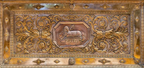  BOLOGNA, ITALY - MARCH 22, 2025: The metallic baroque relief of Lamb of God in the church Chiesa dei Santi Vitale e Agricola in Arena by unknown artist. © Renáta Sedmáková