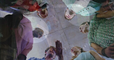 Image of statistical data processing over diverse colleagues stacking hands together at office