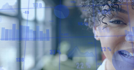 Analyzing adult woman wearing blouse presenting bar charts and pie charts in office, copy space