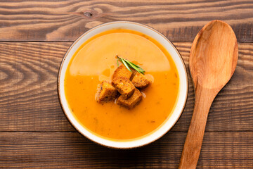 Delicious lentil, ezogelin or pumpkin soup on wooden background