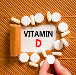 Vitamin D symbol. Concept words Vitamin D on beautiful white paper. White pills tablets. Doctor's...