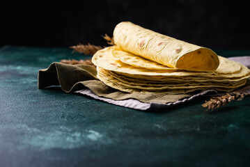 Lavash flat bread on green background