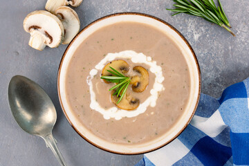 Delicious and healthy mushroom soup on stone background