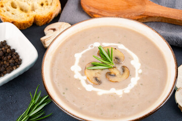 Delicious and healthy mushroom soup on black background