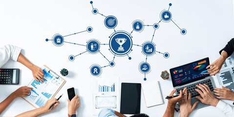 This image captures a collaborative business meeting where team members analyze data on performance and growth using charts and technology, fostering innovative ideas and strategies. Amity