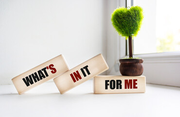 WHAT'S IN IT FOR ME text on wooden blocks and vintage background